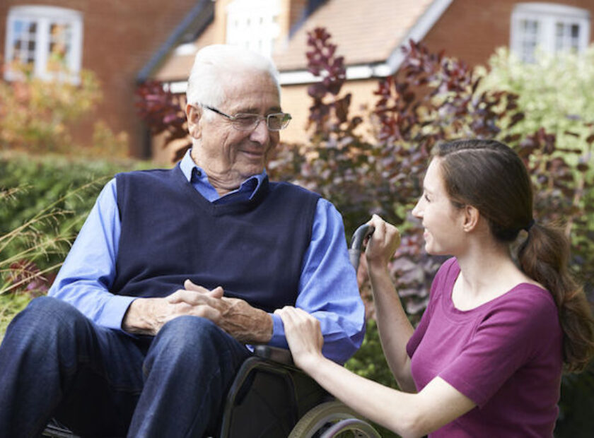 46128998 - adult daughter visiting father in wheelchair